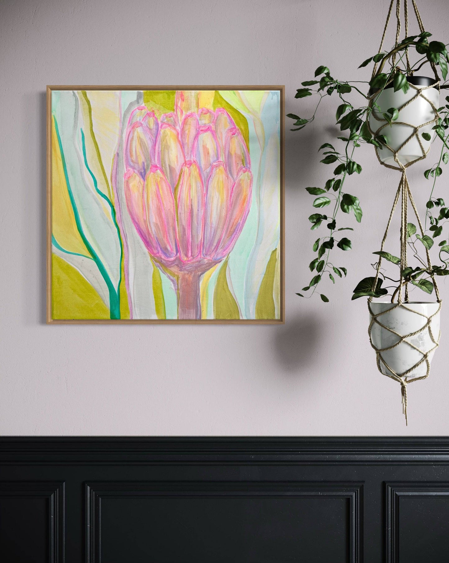 Abstract botanical painting with pink floral shapes on green, yellow and blue background in wooden frame