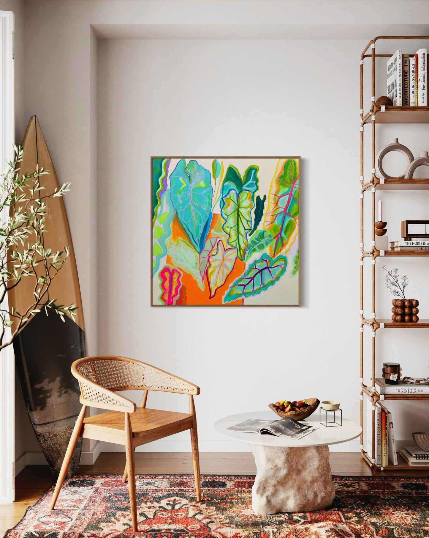 Bright botanical abstract painting by Kathryn Sillince in modern living room with wooden chair and sculptural coffee table