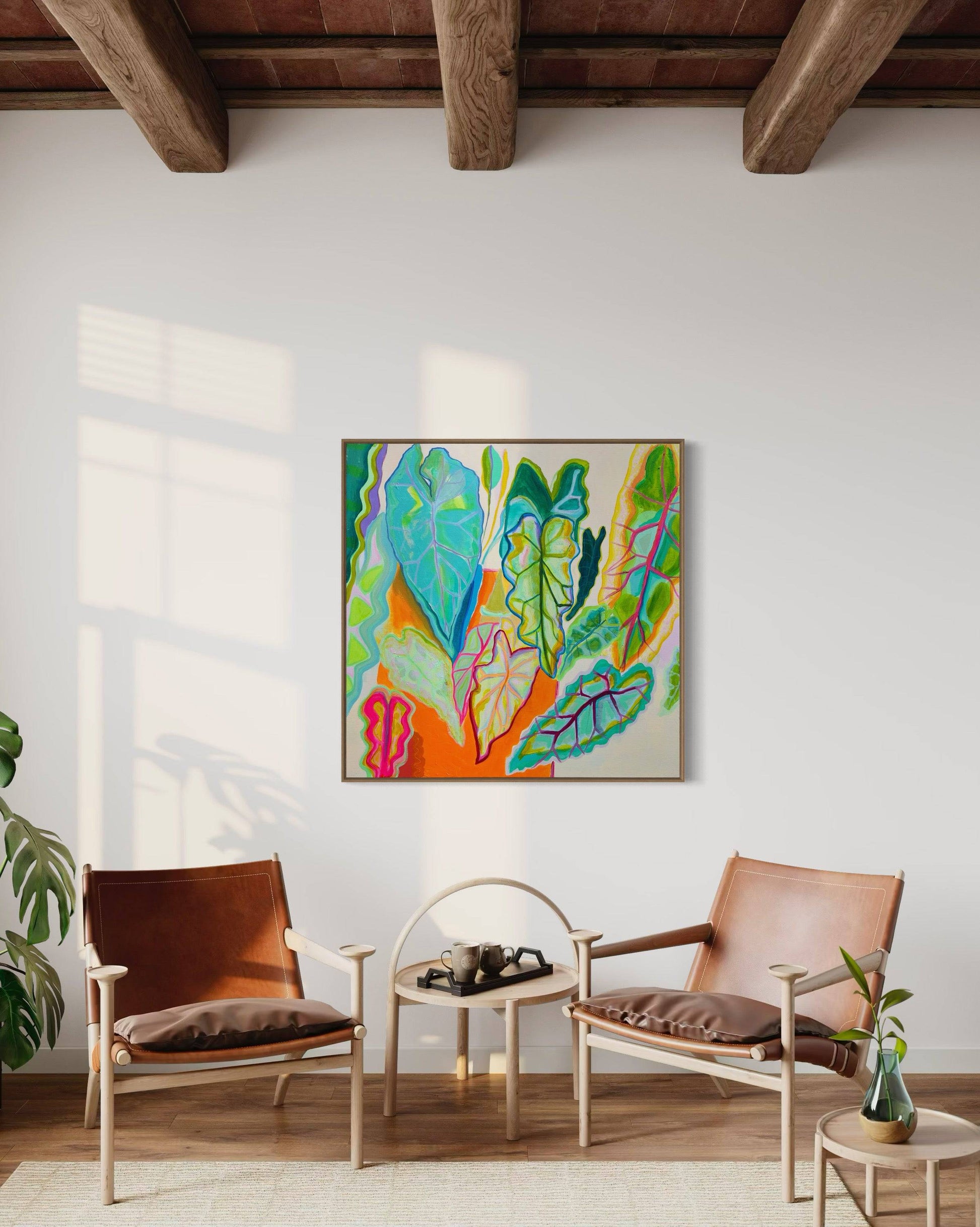 Modern living room with wooden beams, two leather chairs, and Kathryn Sillince's colorful botanical leaf painting