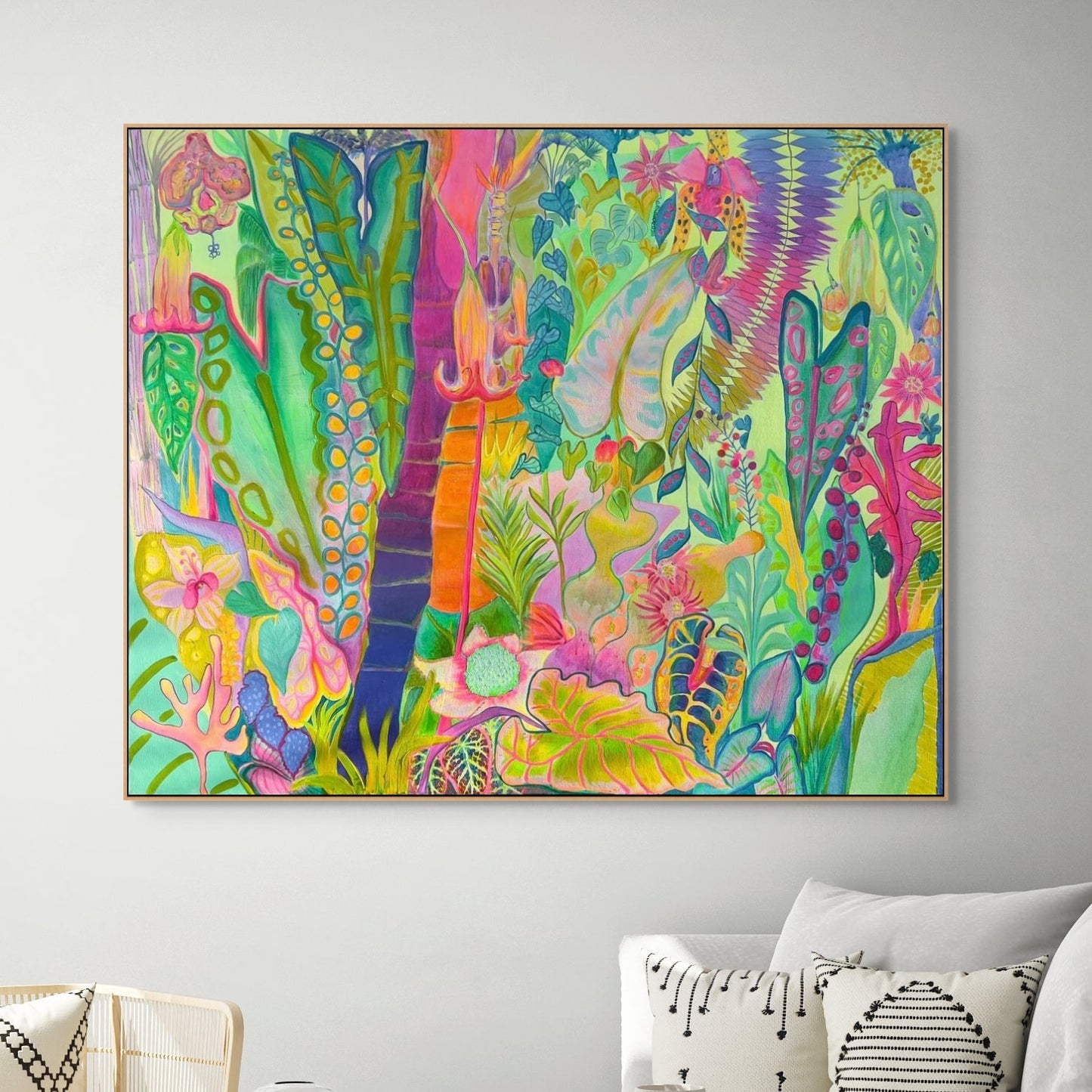 Living room with a colourful large botanical painting on the wall, white sofa, and decorative items.