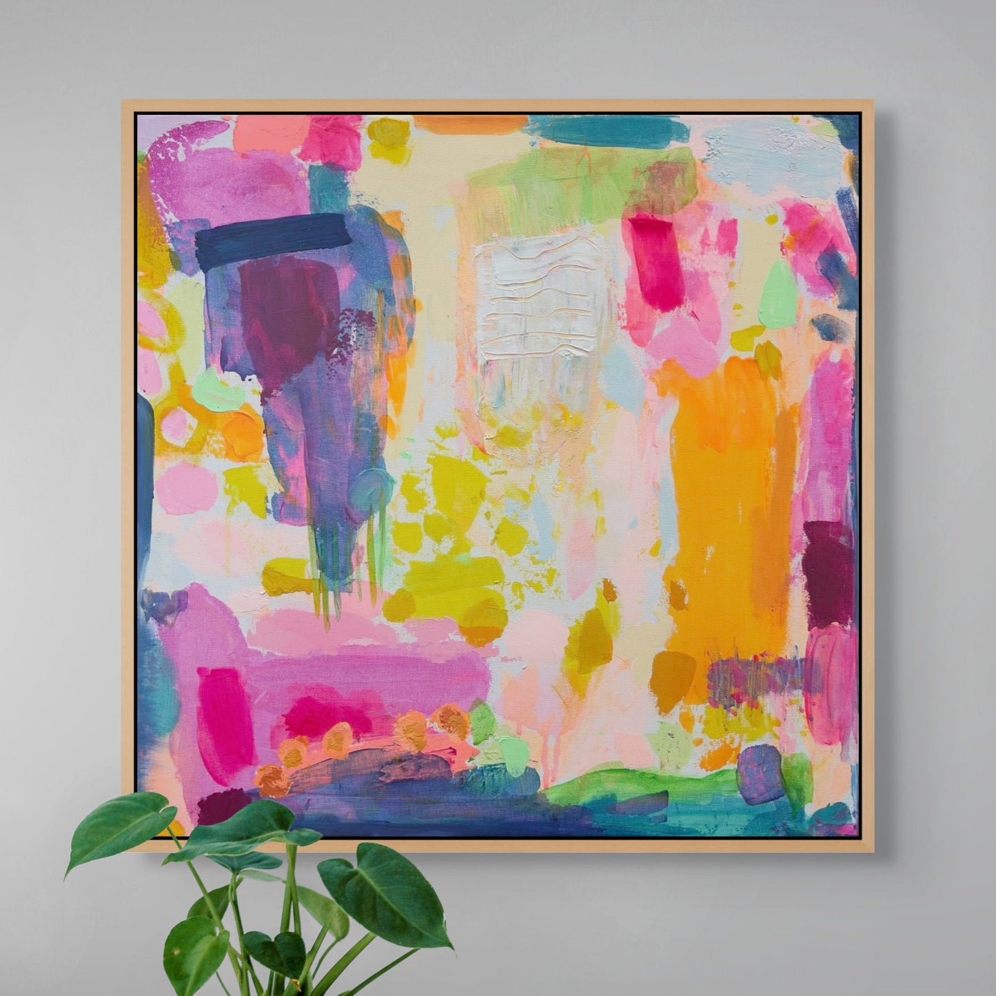 Colourful abstract painting by kathryn sillinceon a gray wall with a plant in the foreground.