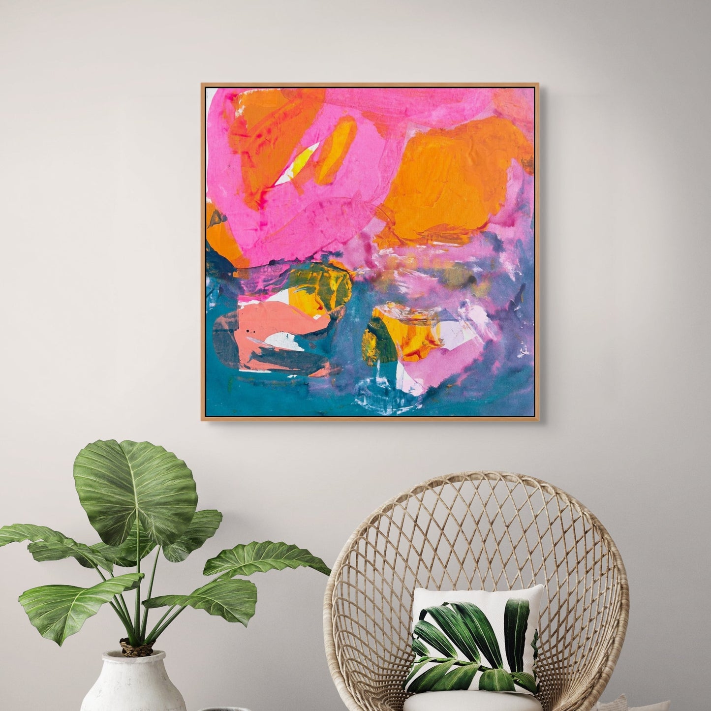 Modern interior with a colorful abstract painting, wicker chair, and plants.