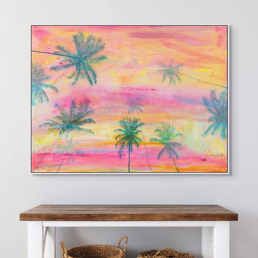 Colorful palm tree painting above a wooden console table with baskets on a white wall.