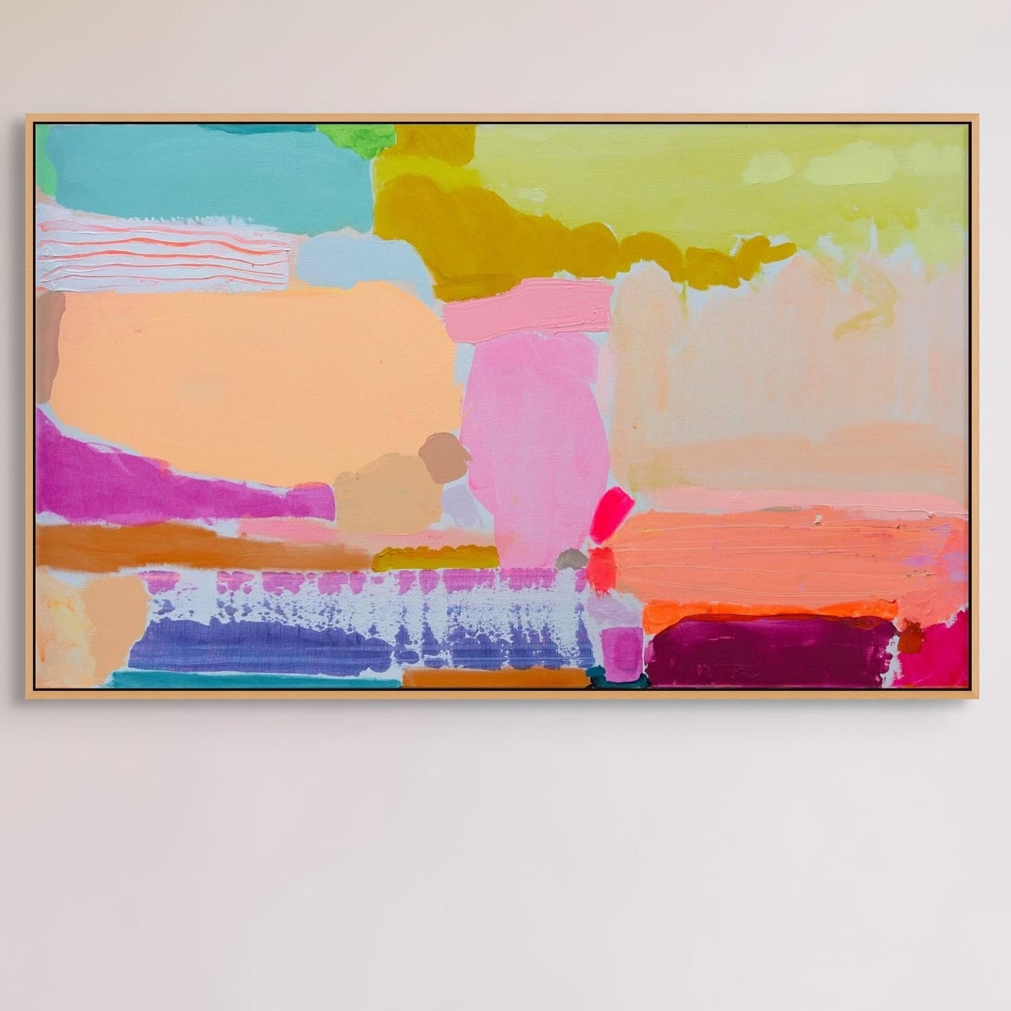 Colorful abstract painting above a bed with white pillows