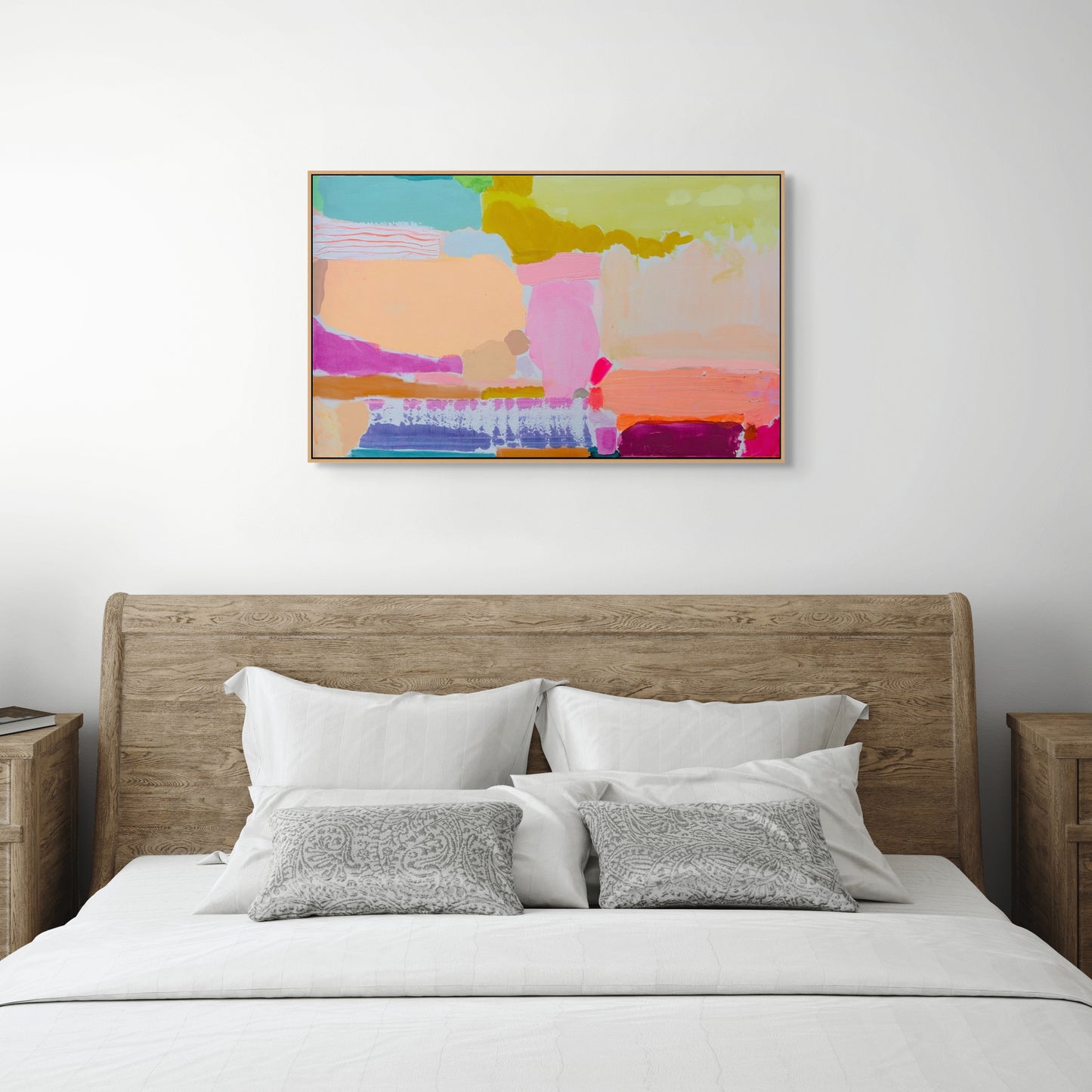 Bedroom with a wooden headboard, white bedding, and a colorful abstract painting on the wall.